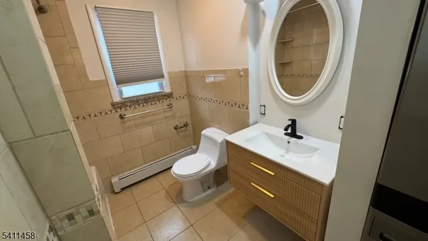 a front view of a house with a garden and deck