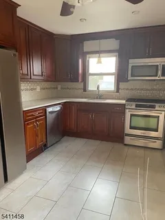 a kitchen with a sink a stove and cabinets