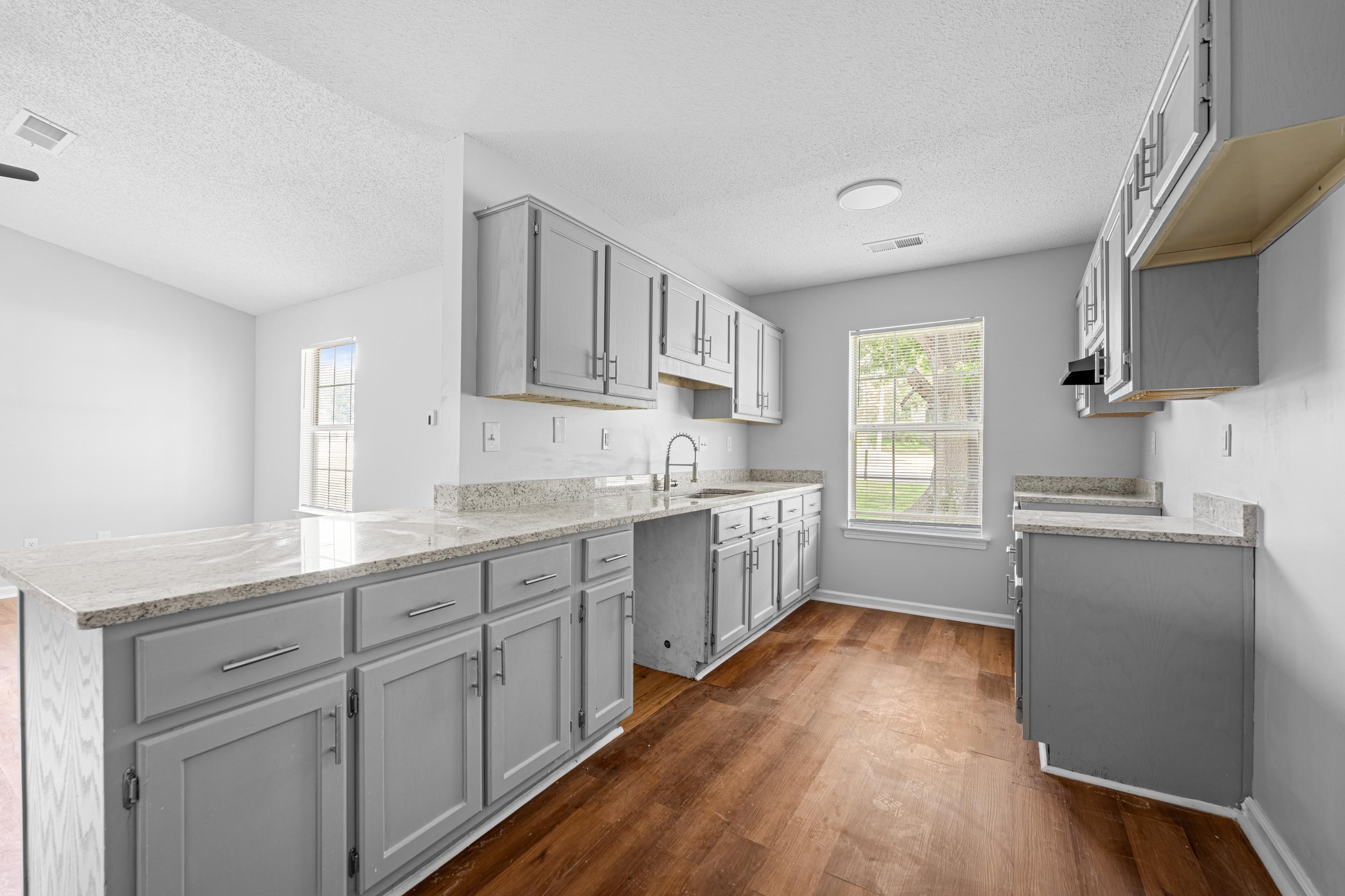3879 Windermere Road Memphis, TN 38128 - Photo 1 of 20 a kitchen with sink cabinets and wooden floor
