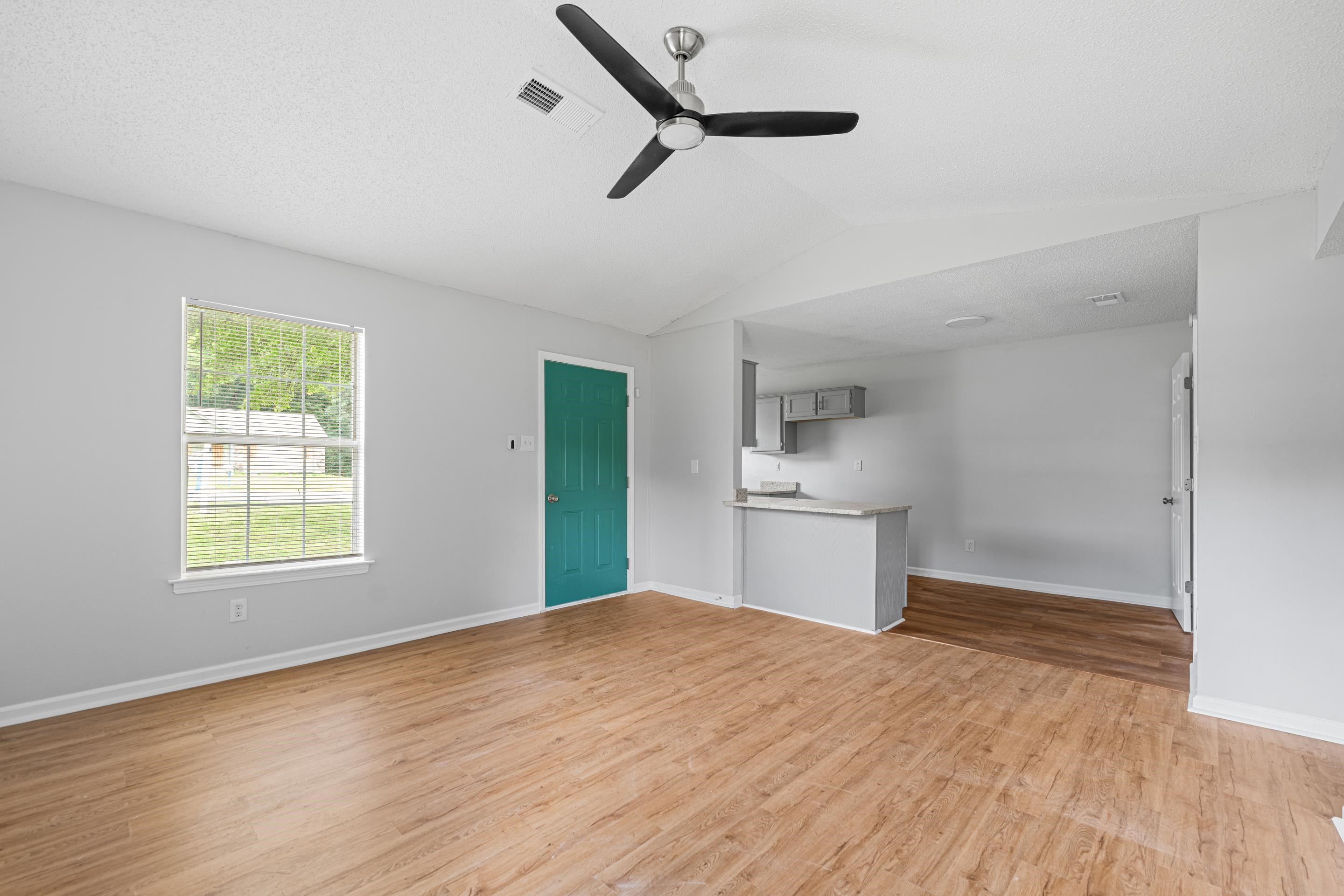 3879 Windermere Road Memphis, TN 38128 - Photo 10 of 20 a kitchen with a wooden floor and a window