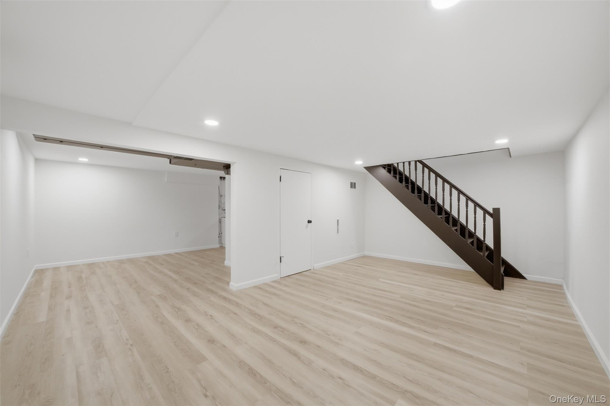 24 Fuller Road Ossining, NY 10562 - Photo 32 of 48 a view of an empty room with wooden floor and stairs