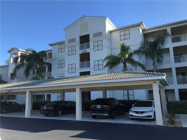 a view of a building with car windows and palm tree