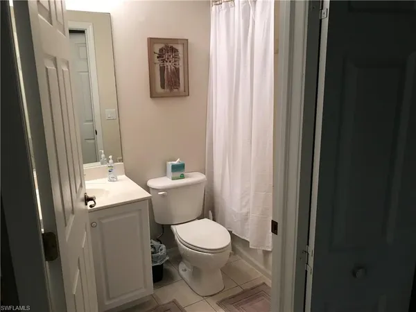 a white toilet sitting next to a bathroom sink