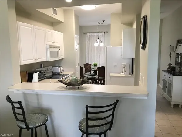 a kitchen with a sink appliances and cabinets