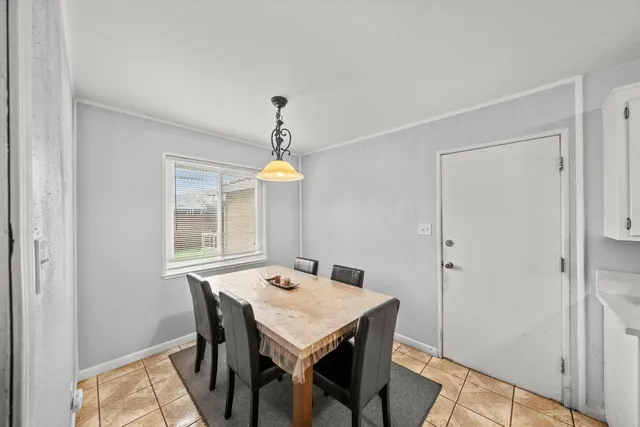 a view of a dining room with furniture and window