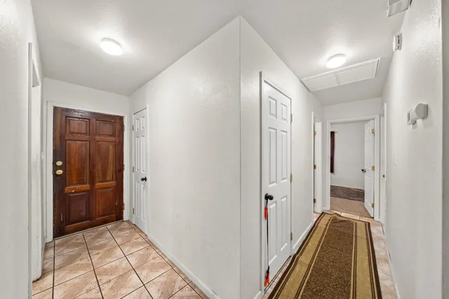 a view of hallway with wooden floor