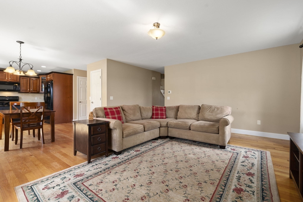 161 Bear Hole Road West Springfield, MA 01089 - Photo 19 of 35 a living room with furniture a wooden floor and a chandelier