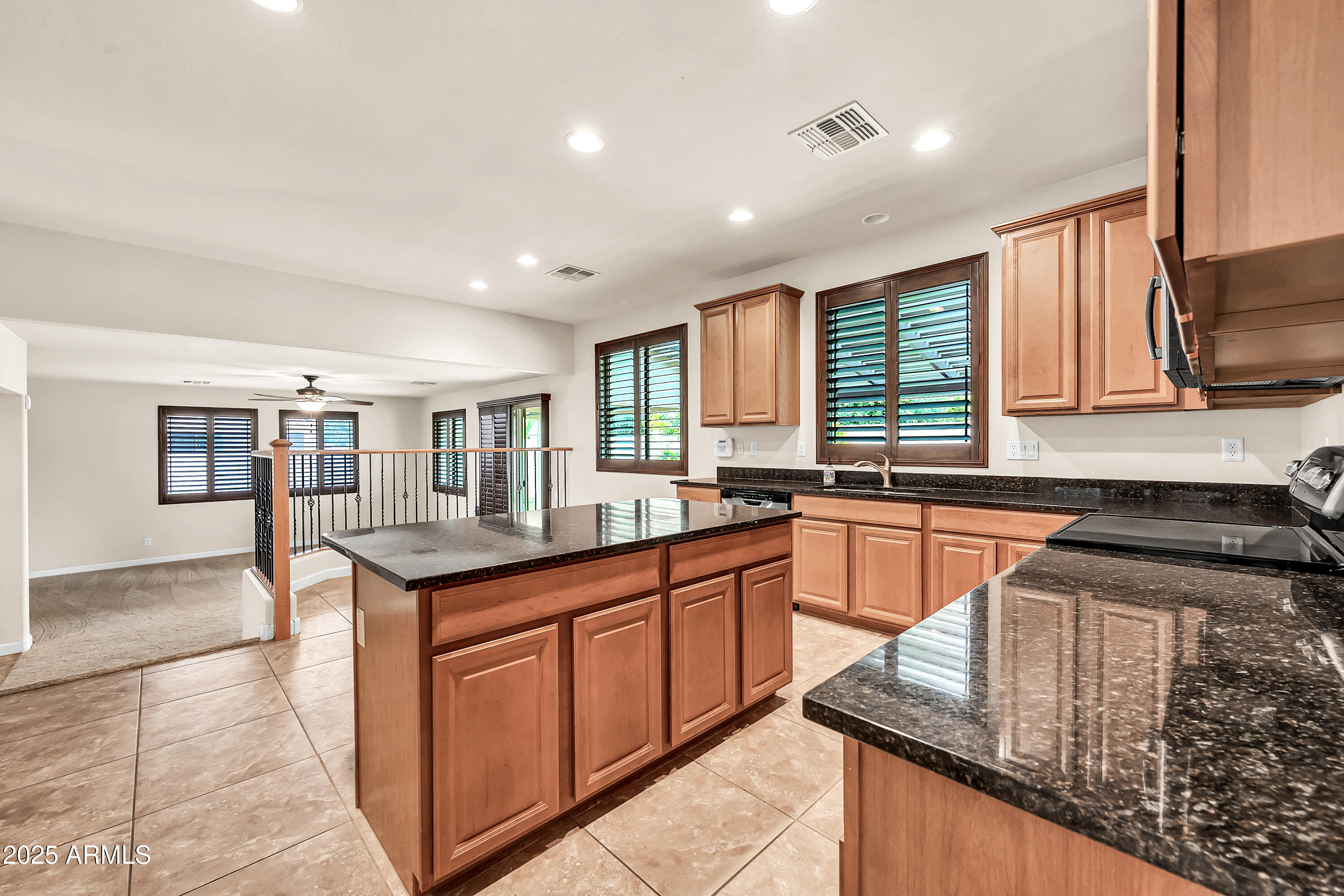 4587 South Ellesmere Street Gilbert, AZ 85297 - Photo 13 of 55 a kitchen with granite countertop kitchen island stainless steel appliances a sink stove and cabinets