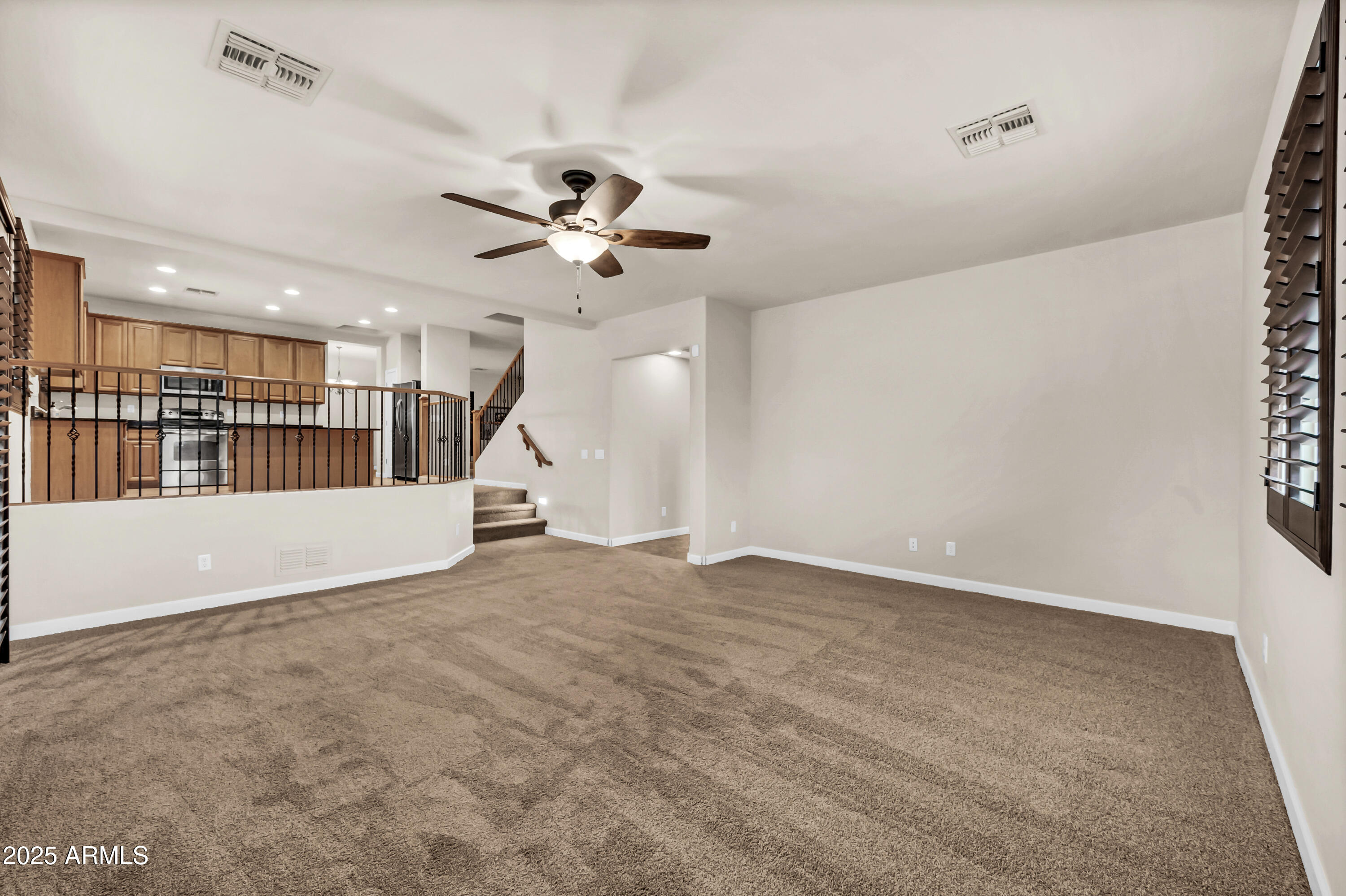 4587 South Ellesmere Street Gilbert, AZ 85297 - Photo 18 of 55 an empty room with a ceiling fan and windows