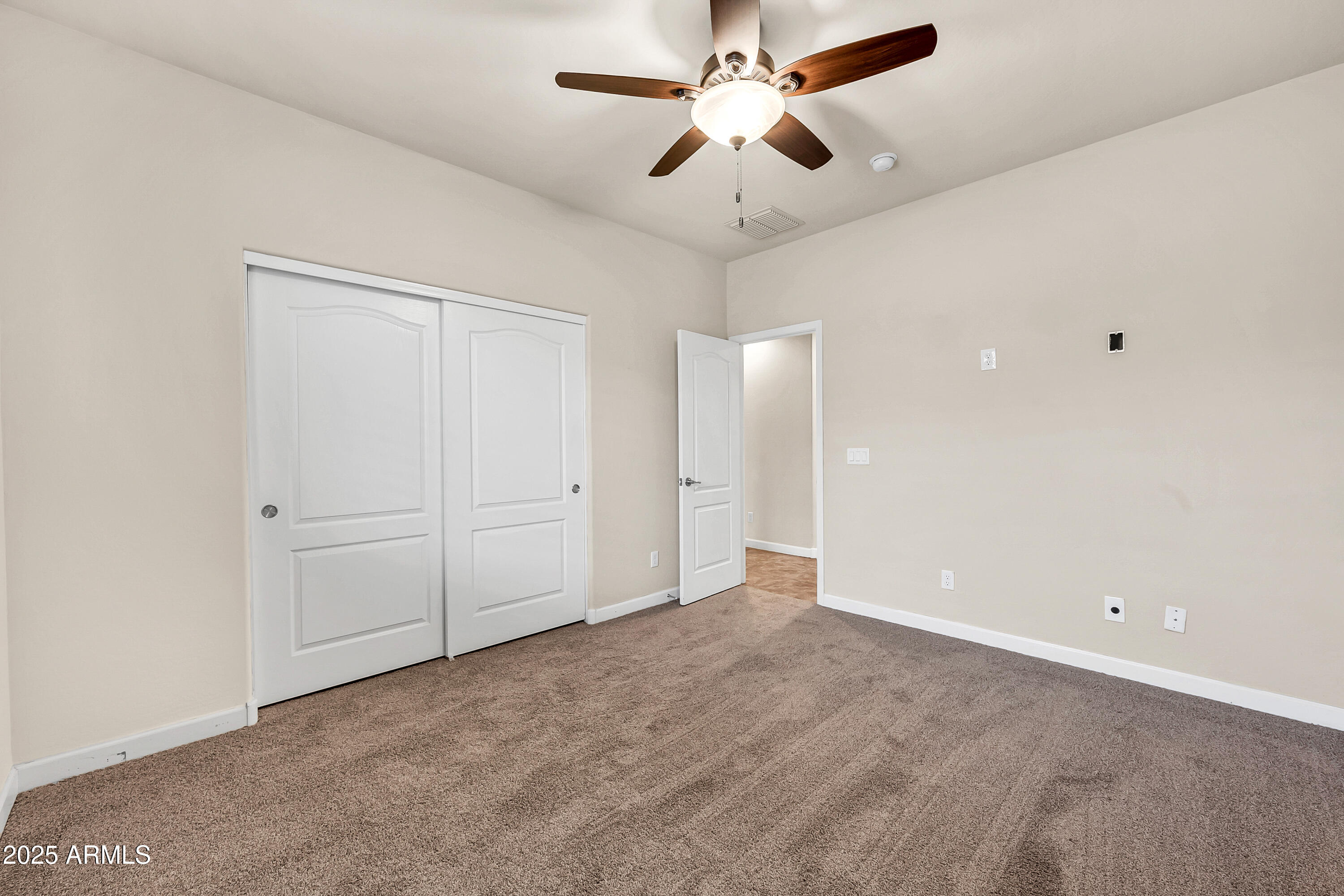 4587 South Ellesmere Street Gilbert, AZ 85297 - Photo 27 of 55 an empty room with closet and a ceiling fan