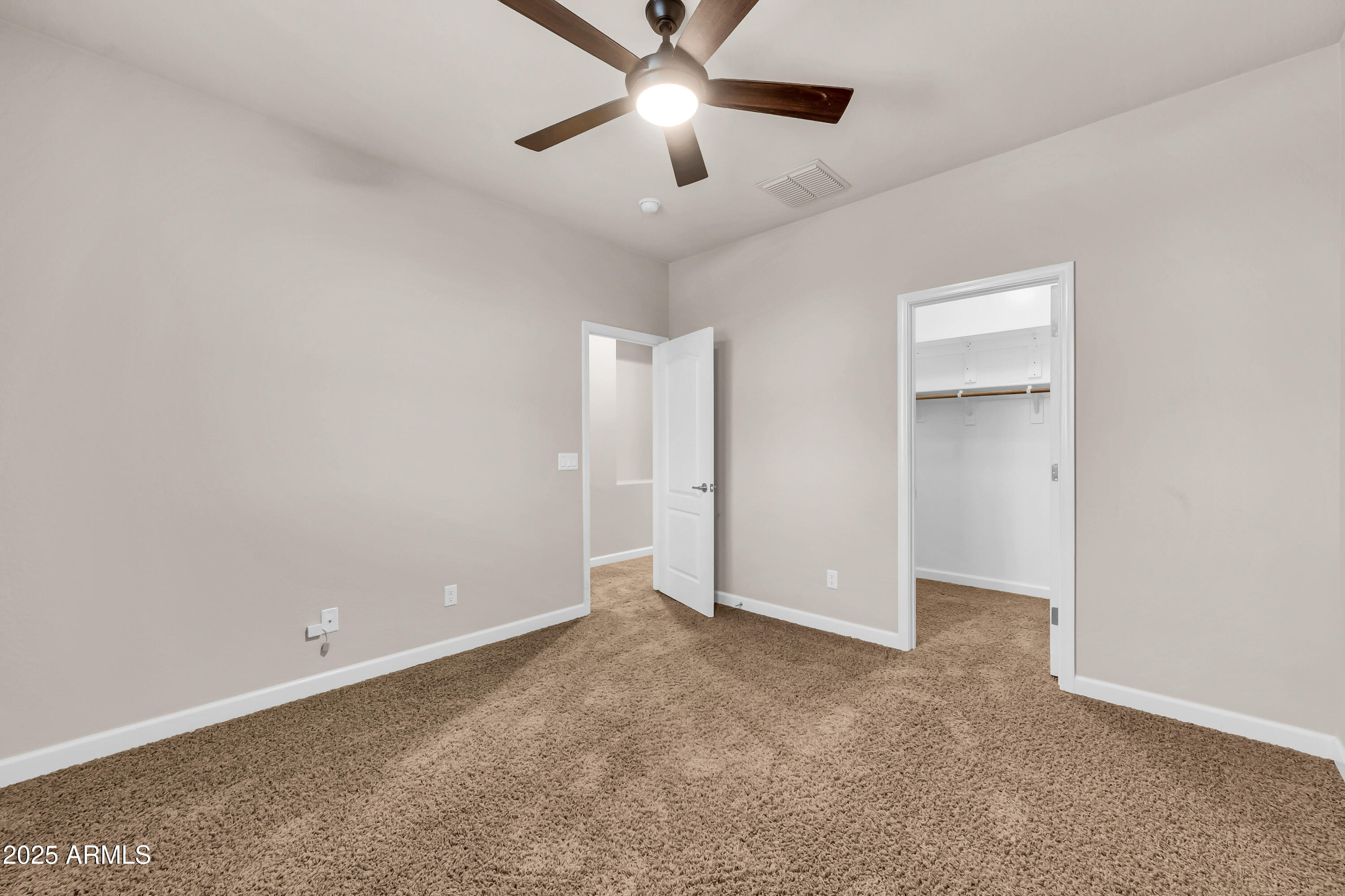 4587 South Ellesmere Street Gilbert, AZ 85297 - Photo 31 of 55 an empty room with closet and a ceiling fan