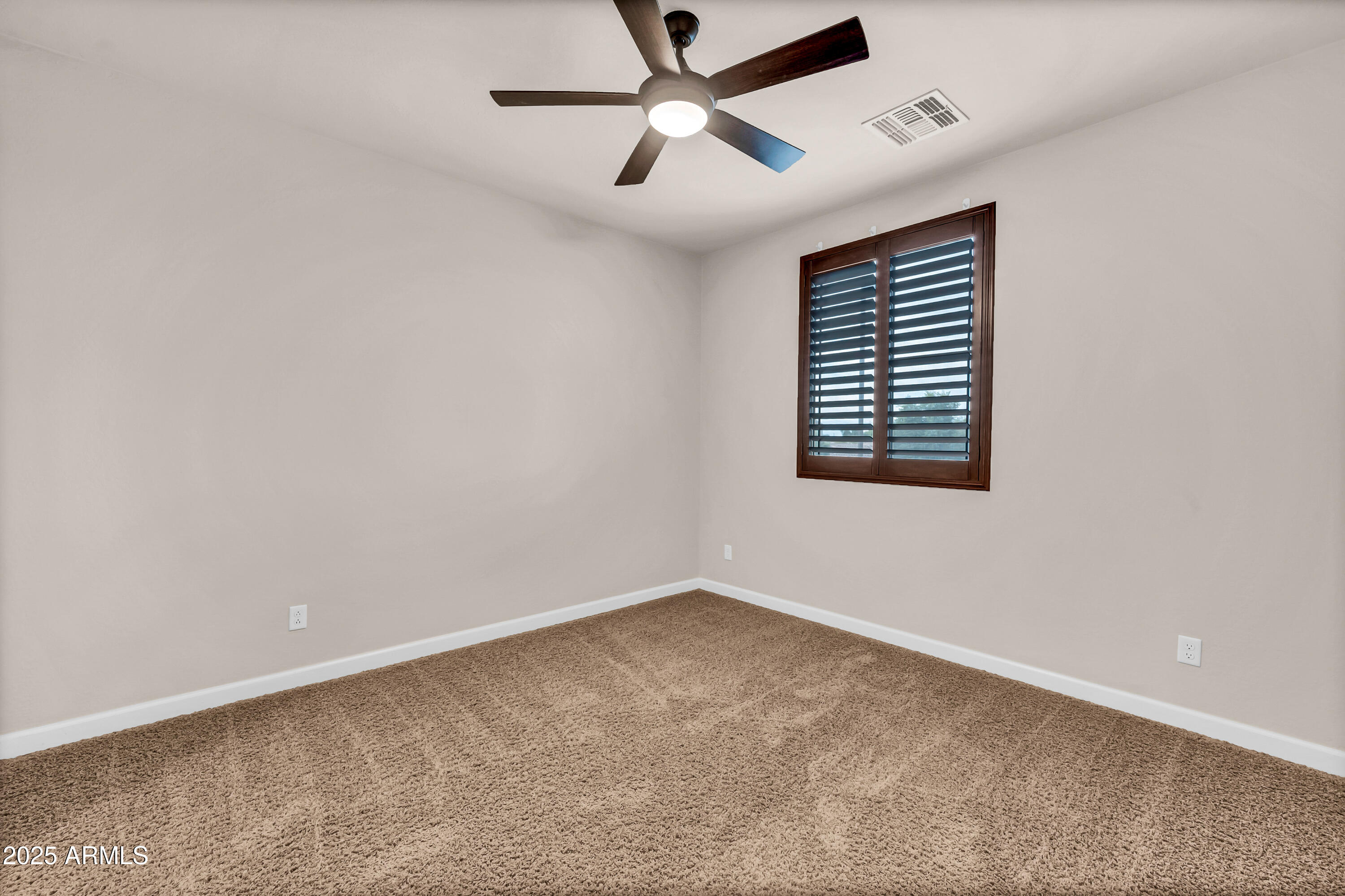 4587 South Ellesmere Street Gilbert, AZ 85297 - Photo 32 of 55 an empty room with a window and a fan