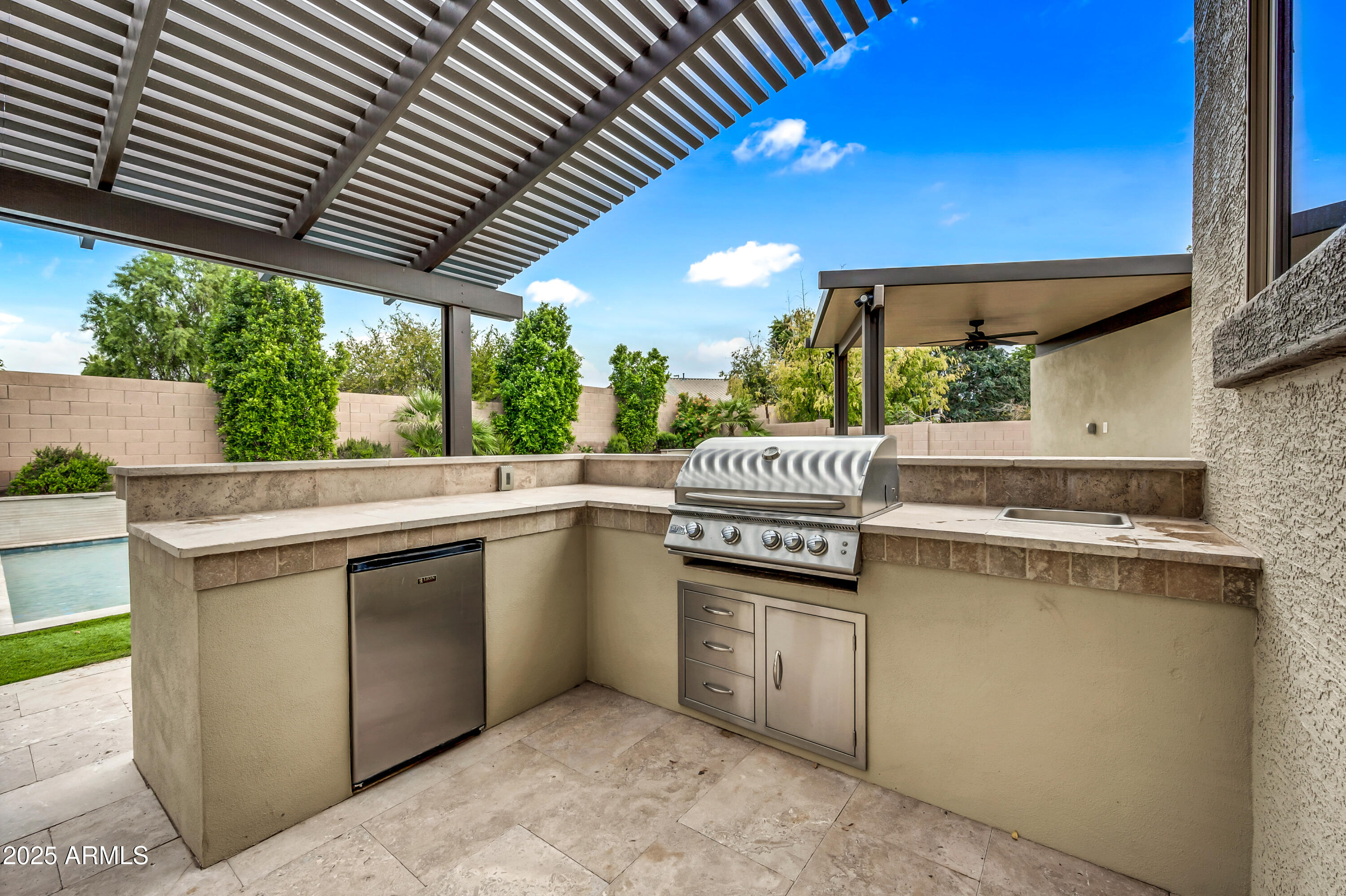 4587 South Ellesmere Street Gilbert, AZ 85297 - Photo 44 of 55 a kitchen with stainless steel appliances granite countertop a sink a stove and a wooden floors