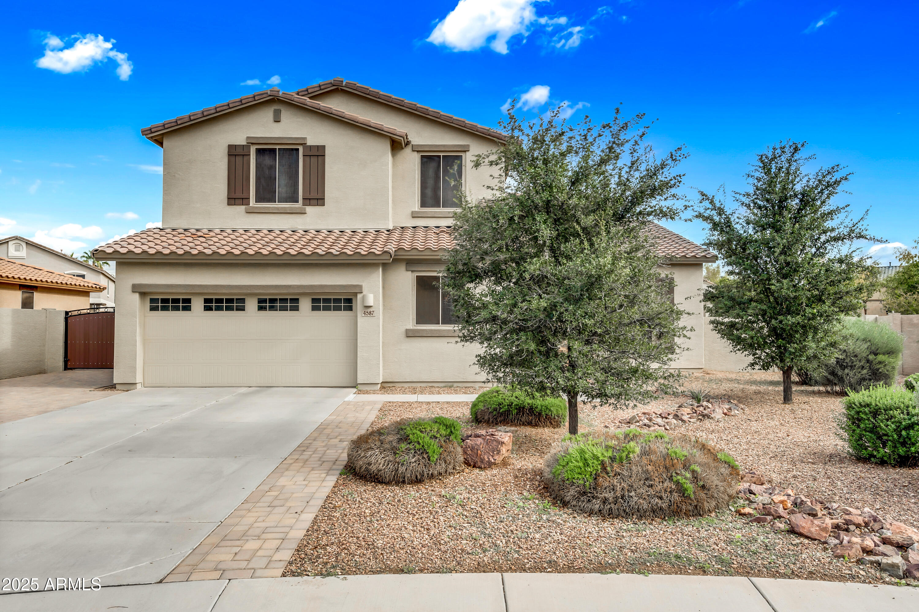 4587 South Ellesmere Street Gilbert, AZ 85297 - Photo 3 of 55 a front view of a house with a yard and garage