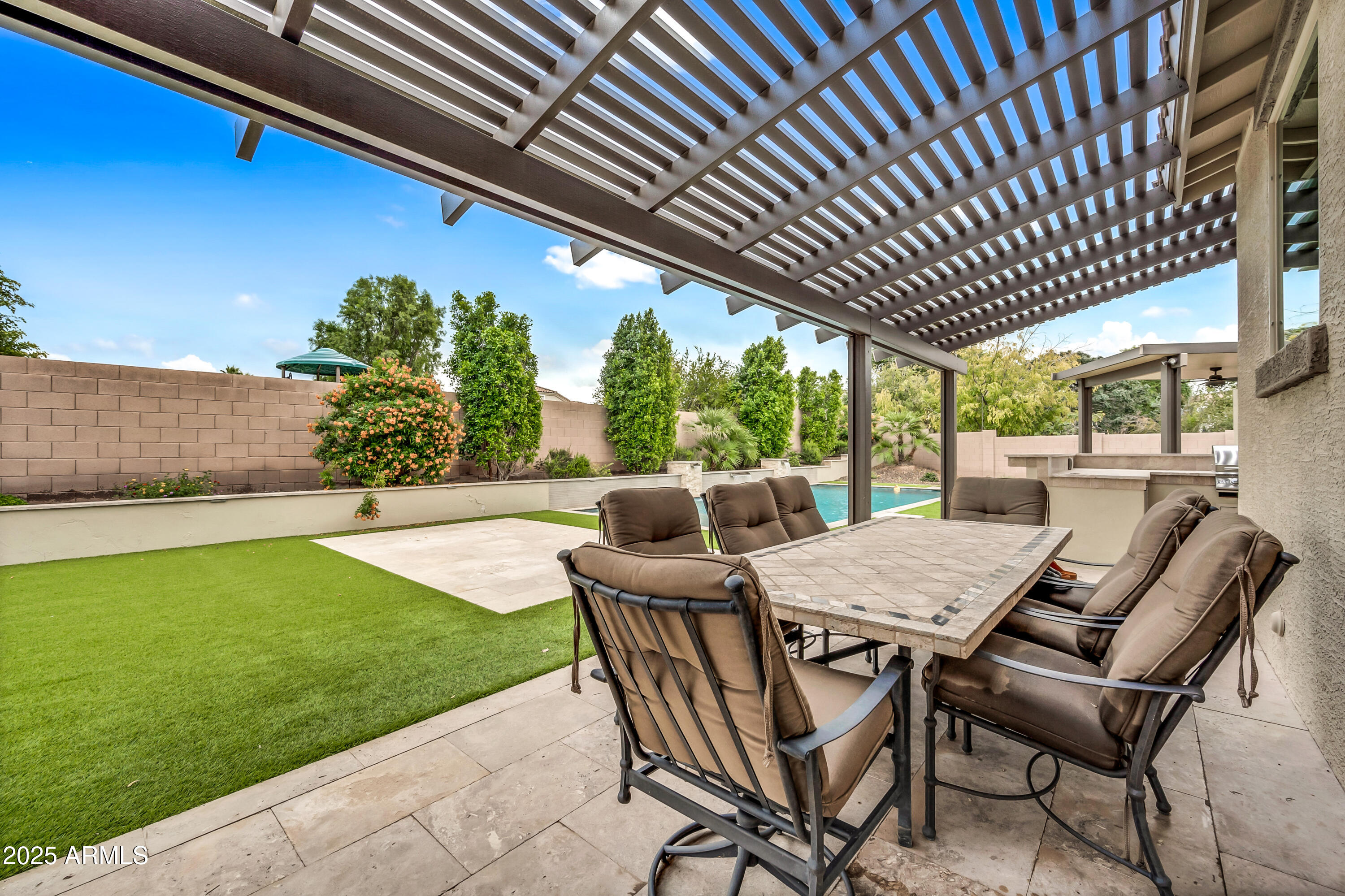 4587 South Ellesmere Street Gilbert, AZ 85297 - Photo 7 of 55 a patio with table and chairs
