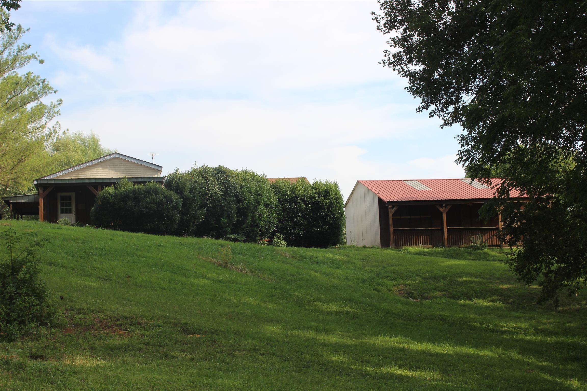 4029 Woodard Road Springfield, TN 37172 - Photo 2 of 16 a backyard of a house with large trees and table and chairs