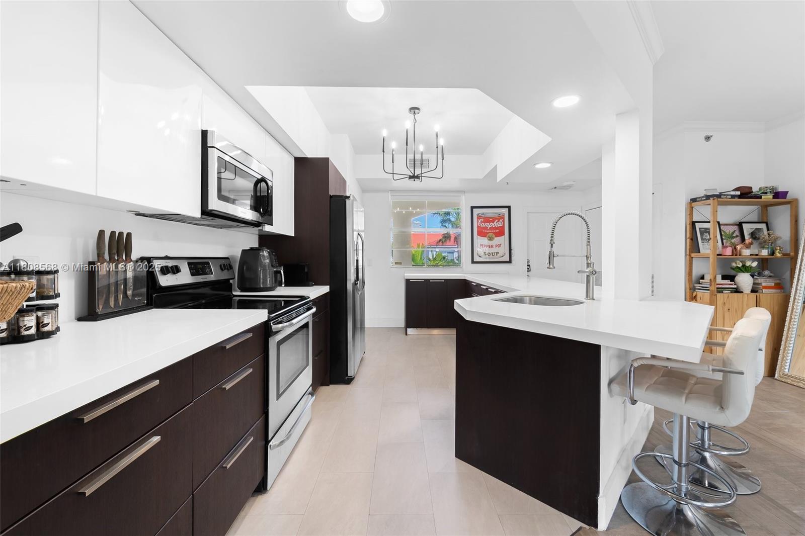 3245 Northeast 184th Street, Unit 13402 Aventura, FL 33160 - Photo 1 of 28 a kitchen with a sink cabinets and wooden floor
