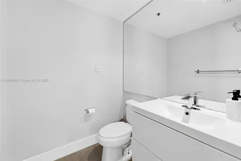 a bathroom with a sink toilet and mirror