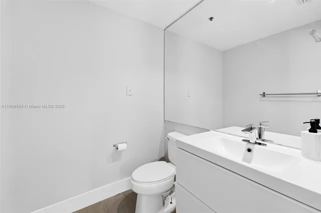 a bathroom with a sink toilet and mirror