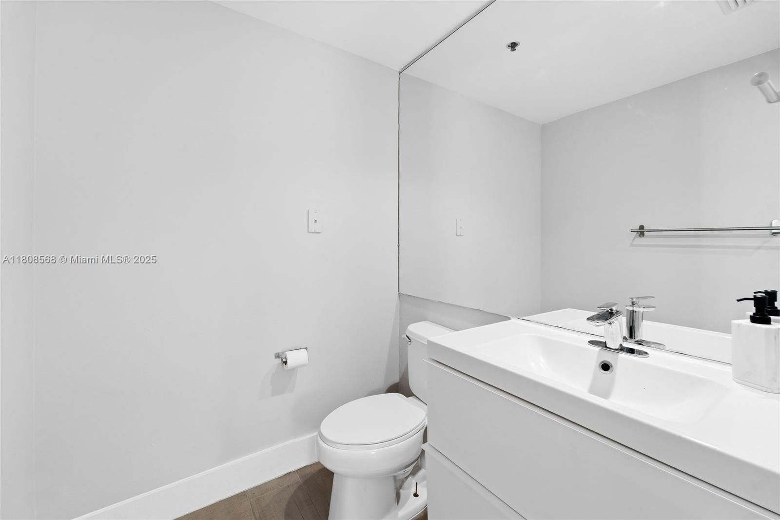 3245 Northeast 184th Street, Unit 13402 Aventura, FL 33160 - Photo 12 of 28 a bathroom with a sink toilet and mirror