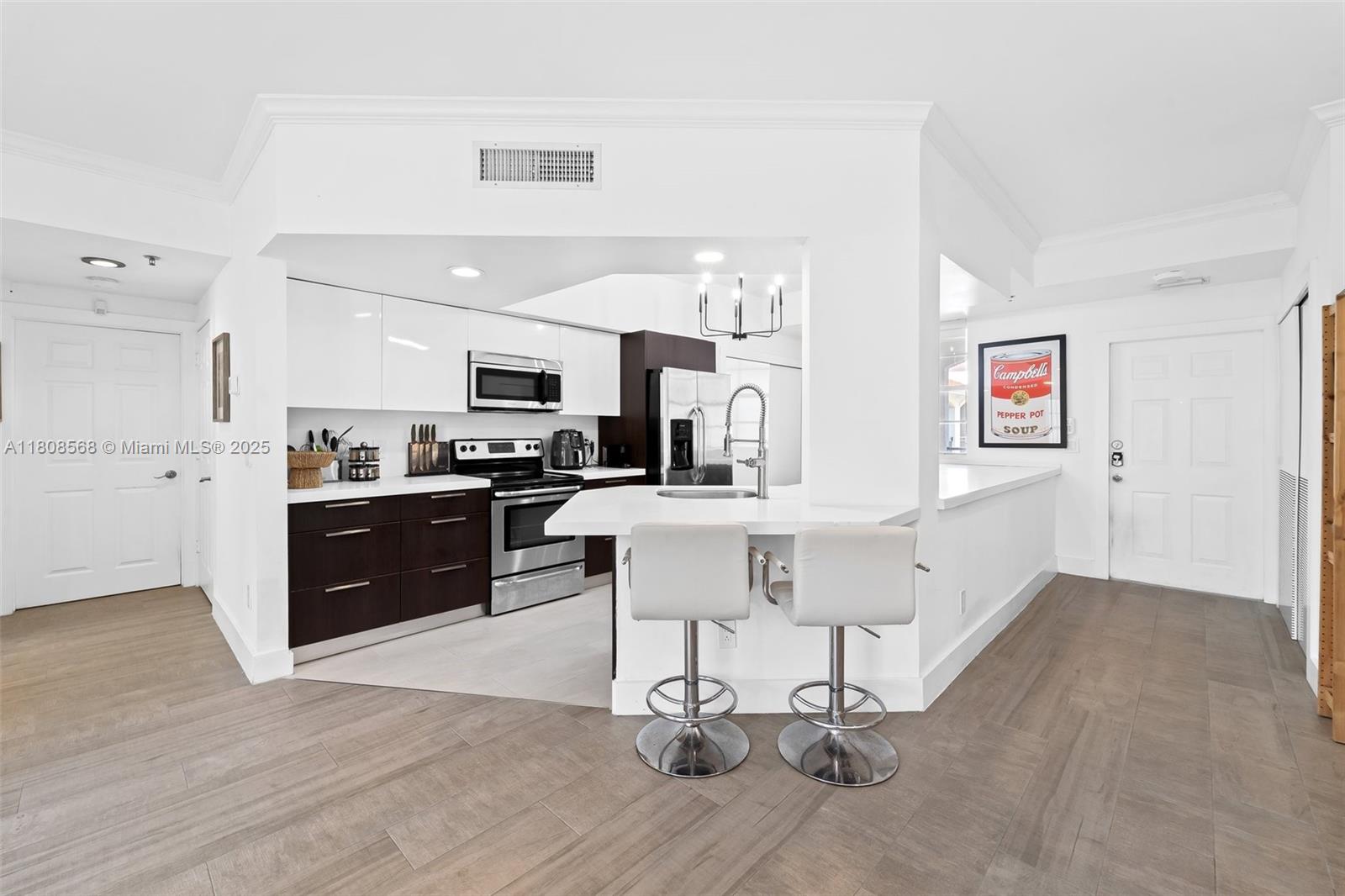 3245 Northeast 184th Street, Unit 13402 Aventura, FL 33160 - Photo 3 of 28 a kitchen with a sink cabinets and wooden floor