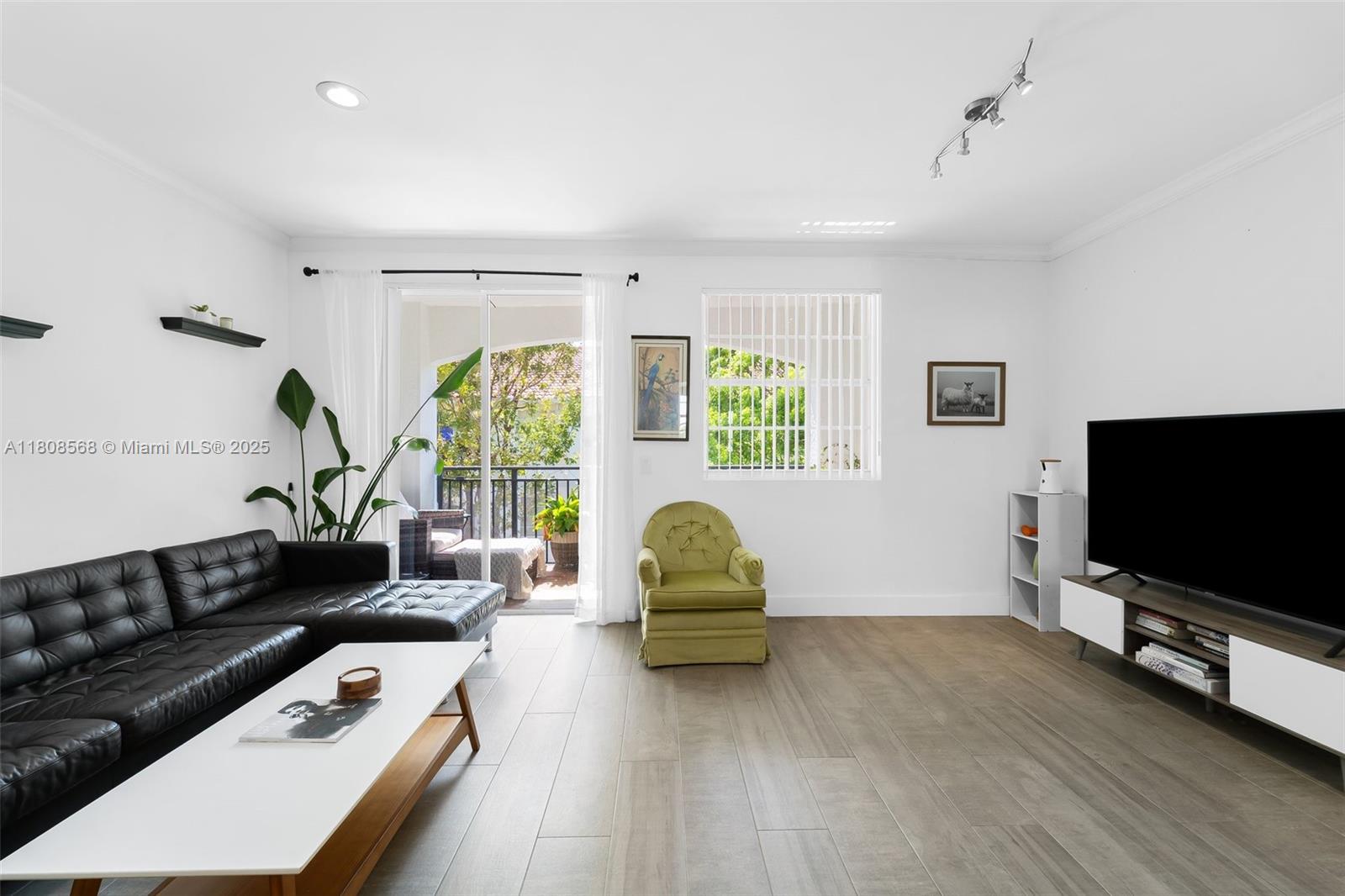 3245 Northeast 184th Street, Unit 13402 Aventura, FL 33160 - Photo 6 of 28 a living room with furniture and a flat screen tv