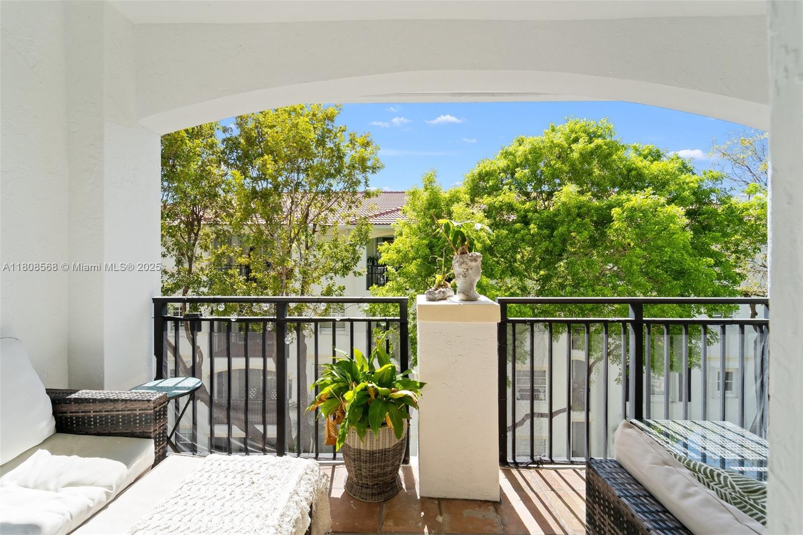 3245 Northeast 184th Street, Unit 13402 Aventura, FL 33160 - Photo 9 of 28 a balcony with wooden floor table and chairs