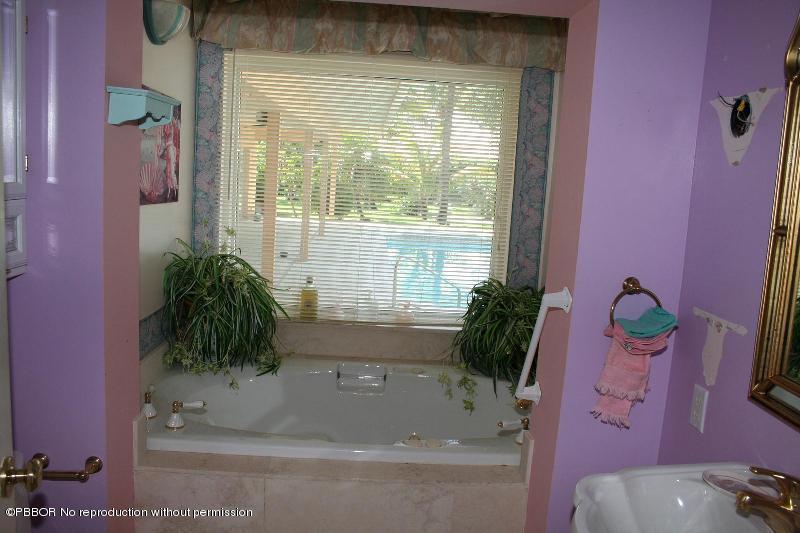 1515 Lands End Road Manalapan, FL 33462 - Photo 13 of 21 a bath tub sitting in a bathroom next to a window