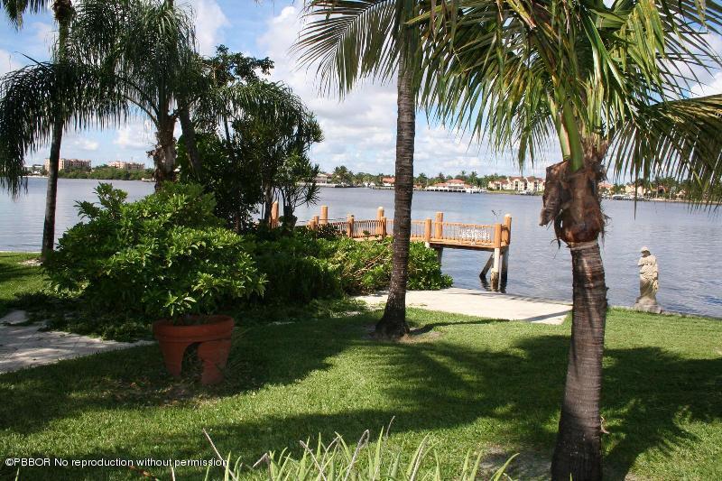 1515 Lands End Road Manalapan, FL 33462 - Photo 19 of 21 a swimming pool with a garden and palm trees