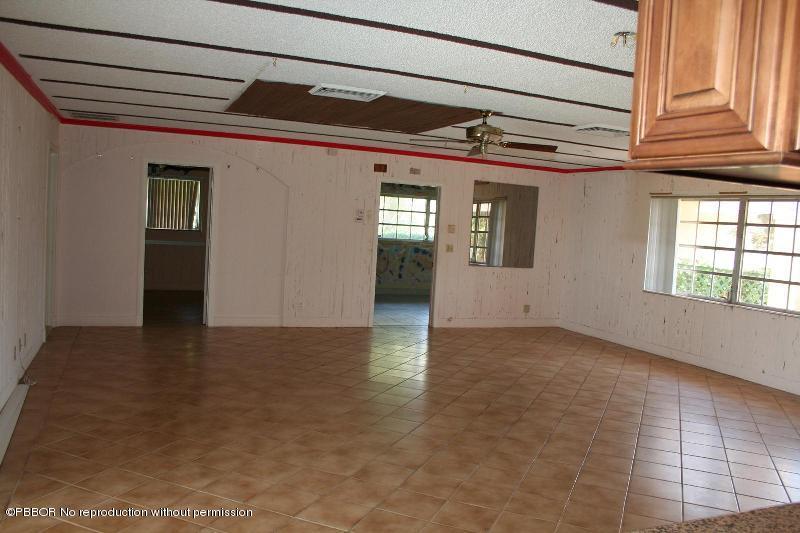 1515 Lands End Road Manalapan, FL 33462 - Photo 7 of 21 a view of a hallway with a window