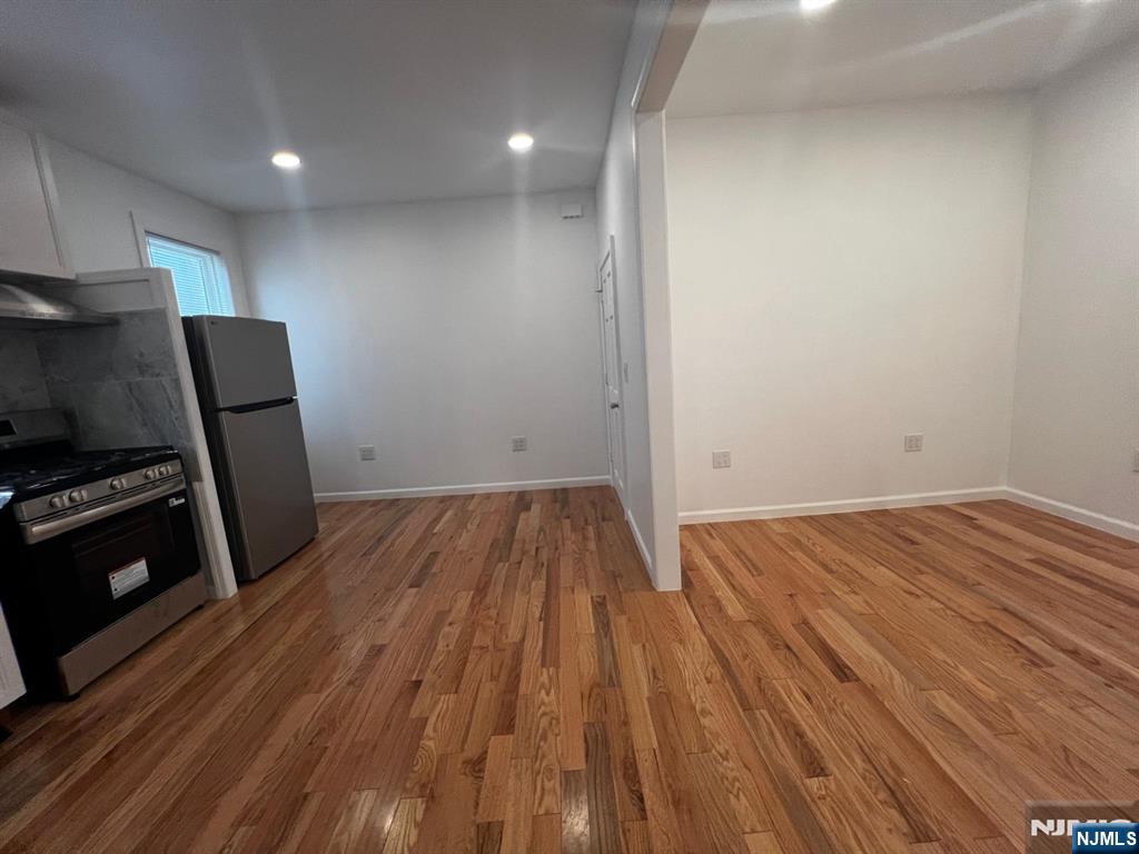 3 Montclair Avenue, Unit 2 Paterson, NJ 07503 - Photo 12 of 24 a view of a room with wooden floor and electronic appliances