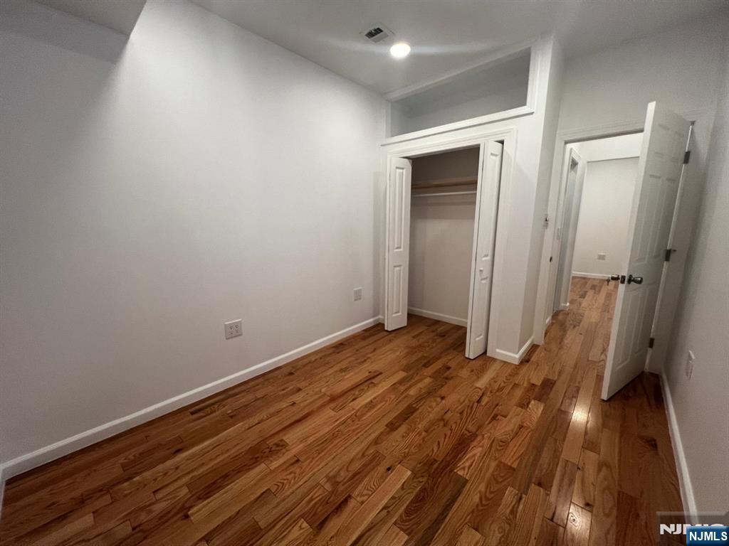 3 Montclair Avenue, Unit 2 Paterson, NJ 07503 - Photo 13 of 24 a view of a room with wooden floor and a bathroom