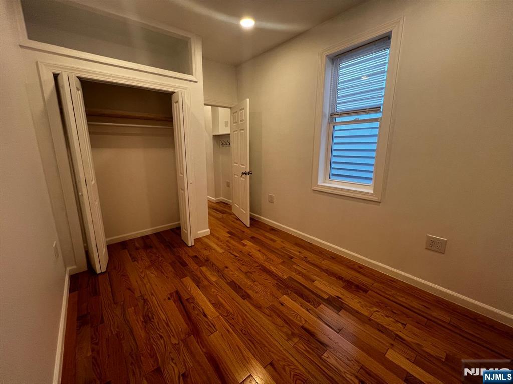 3 Montclair Avenue, Unit 2 Paterson, NJ 07503 - Photo 14 of 24 a view of an empty room with wooden floor and a window