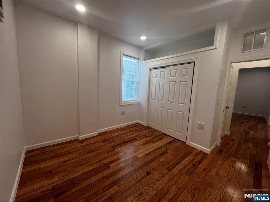 3 Montclair Avenue, Unit 2 Paterson, NJ 07503 - Photo 17 of 24 a view of an empty room with wooden floor and closet