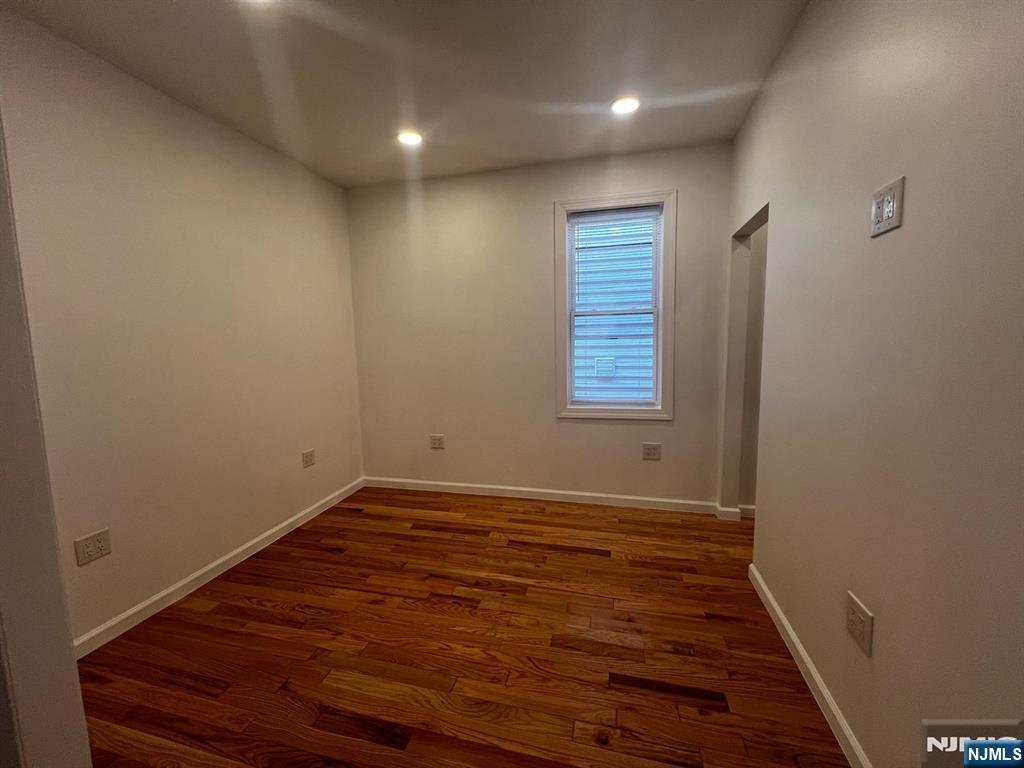 3 Montclair Avenue, Unit 2 Paterson, NJ 07503 - Photo 19 of 24 a view of an empty room with wooden floor and a window