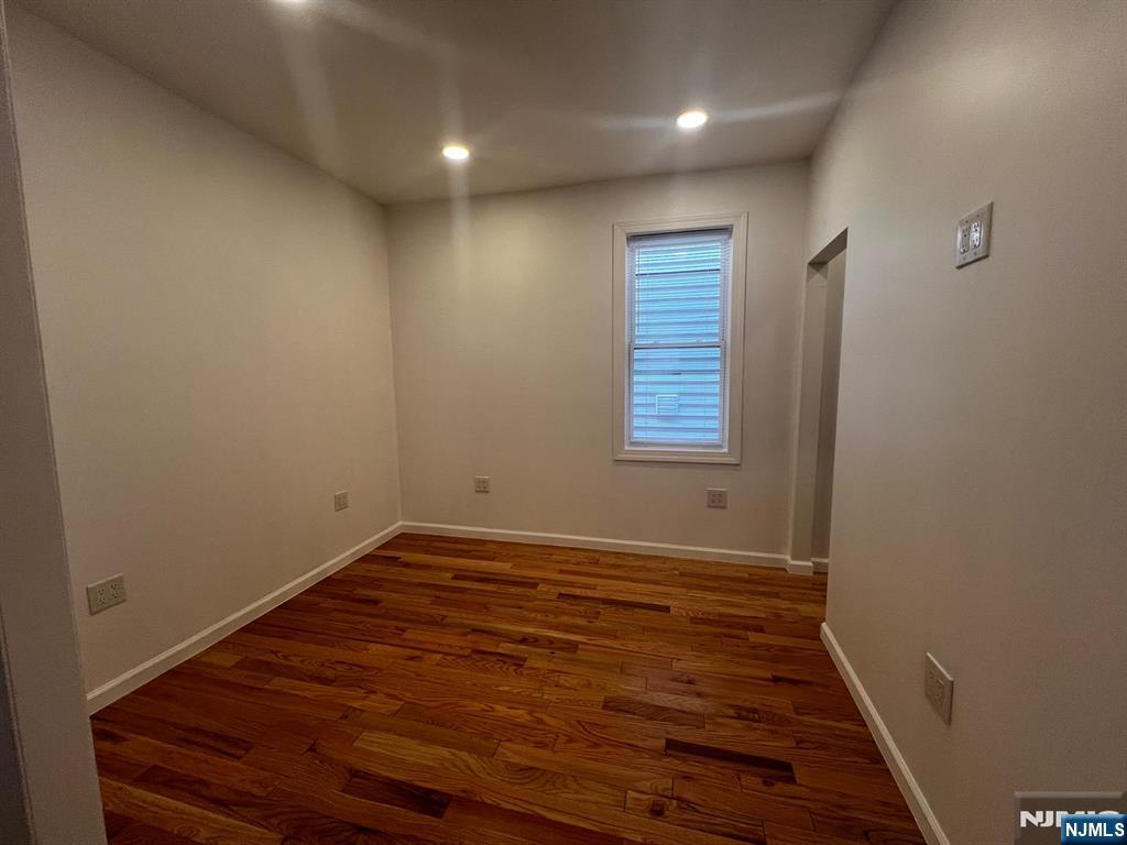 3 Montclair Avenue, Unit 2 Paterson, NJ 07503 - Photo 20 of 24 a view of an empty room with wooden floor and a window