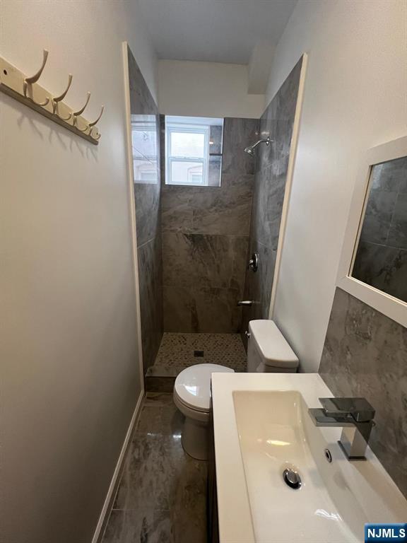 3 Montclair Avenue, Unit 2 Paterson, NJ 07503 - Photo 22 of 24 a bathroom with a sink and toilet