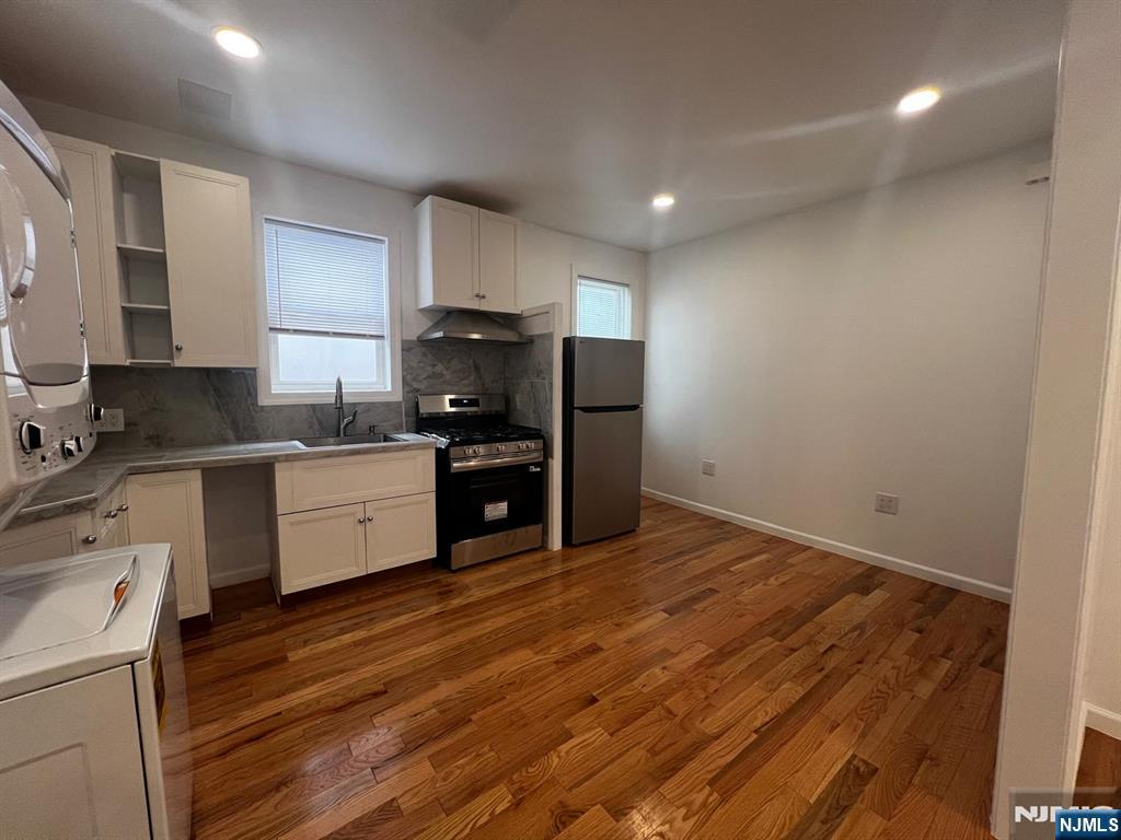 3 Montclair Avenue, Unit 2 Paterson, NJ 07503 - Photo 7 of 24 a kitchen with a sink cabinets stainless steel appliances and a window