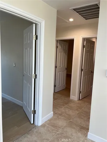 a view of hallway with bathroom