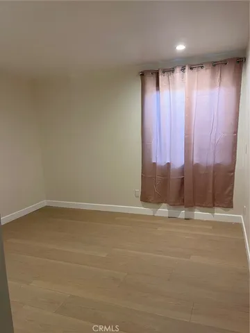 a view of wooden floor and a window
