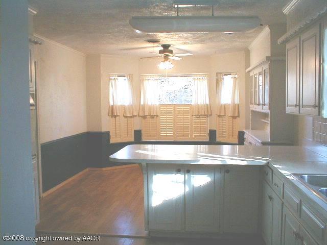 7204 Dreyfuss Road Amarillo, TX 79106 - Photo 6 of 14 a view of a kitchen with a sink and wooden floor