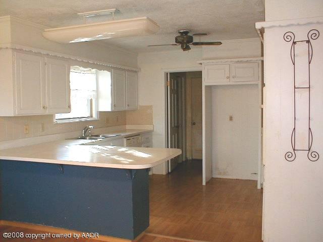 7204 Dreyfuss Road Amarillo, TX 79106 - Photo 7 of 14 a bathroom with a granite countertop sink a mirror and shower