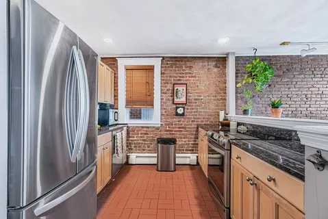 a kitchen with stainless steel appliances a stove sink and refrigerator
