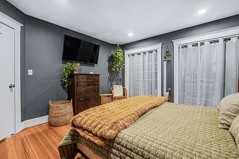 a bedroom with a bed and flat screen tv