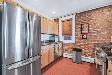 a kitchen with stainless steel appliances a refrigerator sink and cabinets
