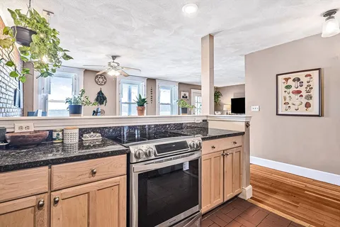 a kitchen with stainless steel appliances granite countertop a stove and a sink