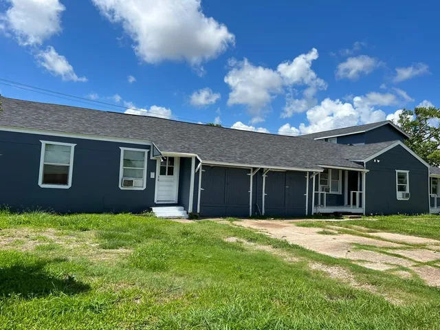 a backyard of a house with large trees