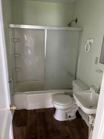 a bathroom with a toilet and a shower