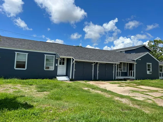 a backyard of a house with large trees