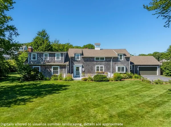 a aerial view of a house with a big yard and potted plants